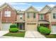 Charming townhome featuring a two-car garage, well-maintained lawn, and inviting entryway at 1622 Honeysuckle Path, Conyers, GA 30012