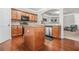 Spacious kitchen features hardwood floors, stainless steel appliances, and a central island at 1622 Honeysuckle Path, Conyers, GA 30012