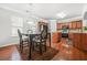 Kitchen and Dining Room showcasing hardwood floors, ample lighting, and open floorplan at 1622 Honeysuckle Path, Conyers, GA 30012