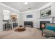 Inviting living room offering a fireplace, comfortable chairs, and seamless access to the kitchen at 1622 Honeysuckle Path, Conyers, GA 30012
