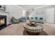 Bright living room showcasing plush carpet, a fireplace, and neutral paint at 1622 Honeysuckle Path, Conyers, GA 30012