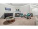 Cozy living room with a fireplace, plush carpeting, and stylish seating arrangement at 1622 Honeysuckle Path, Conyers, GA 30012