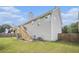 Large fenced backyard featuring green grass and stairs leading to the deck at 251 Hunt Club Cir, Temple, GA 30179