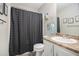 Cozy bathroom featuring a shower with a stylish black curtain and a vanity with a sink at 251 Hunt Club Cir, Temple, GA 30179