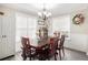 Cozy dining room featuring a wooden table, chairs, and natural light from the surrounding windows at 251 Hunt Club Cir, Temple, GA 30179