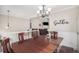 Dining room showcasing a wooden table and chairs with a view into the living room and fireplace at 251 Hunt Club Cir, Temple, GA 30179