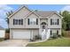 Charming two-story home featuring neutral siding, black shutters and inviting front entrance with landscaped yard at 251 Hunt Club Cir, Temple, GA 30179
