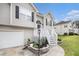 Inviting two-story home features neutral siding, black shutters, and landscaped front yard with an attached garage at 251 Hunt Club Cir, Temple, GA 30179