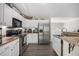Beautiful kitchen featuring stainless steel appliances, modern cabinetry and wood-look floors at 251 Hunt Club Cir, Temple, GA 30179