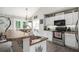 This kitchen features stainless steel appliances and white cabinets with dark countertops at 251 Hunt Club Cir, Temple, GA 30179