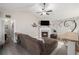Open-concept living room with vaulted ceiling, fireplace, and seamless flow into the adjacent kitchen at 251 Hunt Club Cir, Temple, GA 30179