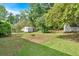 A view of the backyard, showcasing its expansive grassy area and storage sheds at 2664 Olive Springs Se Rd, Marietta, GA 30060