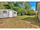 Backyard featuring a storage shed, mature trees, and grassy area at 2664 Olive Springs Se Rd, Marietta, GA 30060