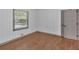 Bedroom featuring a window, hardwood floors, and white paneled walls at 2664 Olive Springs Se Rd, Marietta, GA 30060