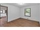 Bedroom featuring a window, hardwood floors, and white paneled walls at 2664 Olive Springs Se Rd, Marietta, GA 30060