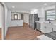Open-concept kitchen with stainless steel appliances, white cabinetry, and a view into an adjacent room enhancing the flow at 2664 Olive Springs Se Rd, Marietta, GA 30060