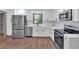 Modern kitchen featuring white cabinets, stainless steel appliances, and quartz countertops, offering a clean and stylish look at 2664 Olive Springs Se Rd, Marietta, GA 30060