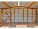 Bright interior of shed with wooden beams, corrugated metal, concrete floor and some shelving at 2664 Olive Springs Se Rd, Marietta, GA 30060