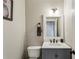 Charming powder room features a modern vanity, toilet and classic accents at 321 Woodbrook Crst, Canton, GA 30114