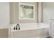 A view of a modern white bathtub with updated fixtures at 321 Woodbrook Crst, Canton, GA 30114