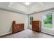 This primary bedroom has neutral walls, carpet floors and bright windows at 321 Woodbrook Crst, Canton, GA 30114