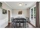 Cozy dining room features a large window with natural light and space for eight at 321 Woodbrook Crst, Canton, GA 30114
