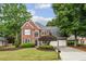 Charming two-story brick home with a well-manicured lawn and mature trees at 321 Woodbrook Crst, Canton, GA 30114