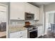 Close-up of kitchen with stainless steel range and granite countertops at 321 Woodbrook Crst, Canton, GA 30114
