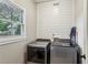 Convenient laundry room features modern washer and dryer with horizontal wood trim at 321 Woodbrook Crst, Canton, GA 30114