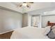 Bright main bedroom with tray ceilings, neutral carpet, and large window at 321 Woodbrook Crst, Canton, GA 30114
