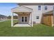 Covered patio with fan and access to the backyard providing an outdoor living space and lush lawn at 867 Pensive Run, Dacula, GA 30019
