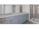 Bathroom featuring double sinks, granite countertops and a walk-in shower at 867 Pensive Run, Dacula, GA 30019