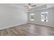 Bright bedroom featuring a tray ceiling, recessed lighting, and large windows at 867 Pensive Run, Dacula, GA 30019