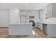 Modern kitchen featuring stainless steel appliances, a large island, and granite countertops at 867 Pensive Run, Dacula, GA 30019