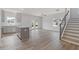 Open-concept living space with hardwood floors, modern staircase and access to the backyard at 867 Pensive Run, Dacula, GA 30019