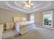 Bright bedroom features two windows and a ceiling fan to circulate the air at 1012 Gloria Grand Blvd, Mcdonough, GA 30252