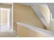 Hallway with neutral paint and carpet and access to upstairs rooms at 1012 Gloria Grand Blvd, Mcdonough, GA 30252