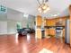 Open-concept kitchen and living room featuring hardwood floors and stainless appliances at 1012 Gloria Grand Blvd, Mcdonough, GA 30252