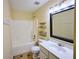 A well-lit bathroom features a bathtub, a toilet, and a sink with a large mirror at 3350 Cooper Woods Dr, Loganville, GA 30052
