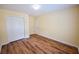 Empty bedroom with vinyl floors, closet, and door in a clean, bright space at 3350 Cooper Woods Dr, Loganville, GA 30052