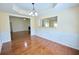Dining room boasts elegant wainscoting, hardwood floors, and a view into the adjacent living spaces at 3350 Cooper Woods Dr, Loganville, GA 30052