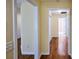 Bright hallway showing wood-look flooring, with open doorways at 3350 Cooper Woods Dr, Loganville, GA 30052