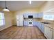 A spacious kitchen features tile floors, a white refrigerator, and modern appliances at 3350 Cooper Woods Dr, Loganville, GA 30052