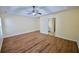 Main bedroom with wood-look flooring, ceiling fan, and attached bathroom at 3350 Cooper Woods Dr, Loganville, GA 30052