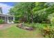 Lush backyard with manicured lawn, landscaping, screened porch, and mature trees at 3510 Smoke Rise Way, Lawrenceville, GA 30044