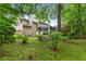 Spacious backyard featuring a screened porch, lush lawn, and mature trees at 3510 Smoke Rise Way, Lawrenceville, GA 30044