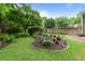 Landscaped backyard with mature trees, garden and green grass at 3510 Smoke Rise Way, Lawrenceville, GA 30044