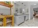 Bright bathroom features a double vanity, neutral toned floor tiles, and a bamboo shelving unit at 3510 Smoke Rise Way, Lawrenceville, GA 30044