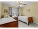 Bright bedroom with two twin beds, yellow walls, and natural light from the window at 3510 Smoke Rise Way, Lawrenceville, GA 30044
