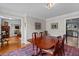 Elegant dining room with hardwood table, rug, and a view to the kitchen at 3510 Smoke Rise Way, Lawrenceville, GA 30044
